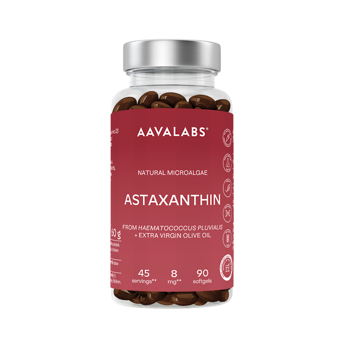 A bottle of AAVALABS Astaxanthin dietary supplements, featuring a dark red label and a metallic silver cap, filled with brown softgels.