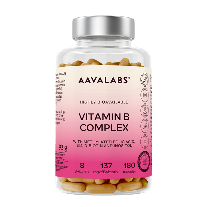 A clear plastic bottle of AAVALABS Vitamin B Complex capsules with a silver cap and a pink-to-cream label, showing the tan capsules inside.